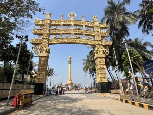 Street view of Dadar with busy traffic, railway station, and iconic Central Mumbai buildings.