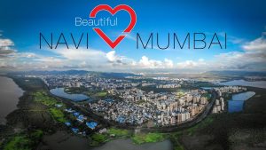 Wide-angle view of Navi Mumbai skyline with modern buildings, open roads, and palm-lined streets.
