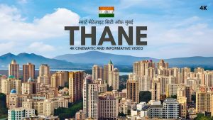 Cityscape of Thane showing Upvan Lake, residential towers, and surrounding hills under a clear sky.